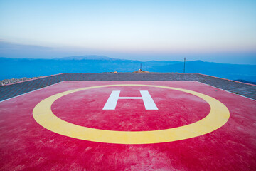 Helipad on mountain top, helicopter landing site on hill area