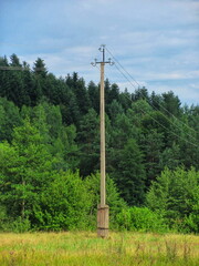 Sentinel of Power: A Concrete Pylon Stands Tall Amidst the Tranquil Landscape
