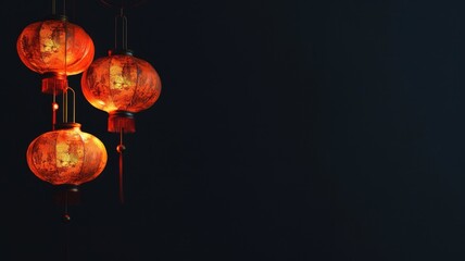 Fototapeta premium Red lanterns hanging against dark background, creating festive atmosphere
