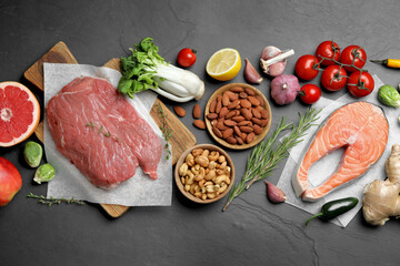 Flat lay composition with fresh meat and other products for balanced diet on black table