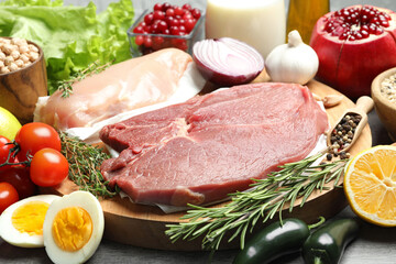 Fresh meat and other products for balanced diet on table