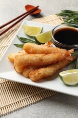 Delicious breaded fried shrimps served on grey table