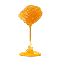 Honey dripping from honeycomb on white background