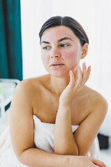 Close-up of a woman's face with redness. Mask on the face of your client in the beauty salon....