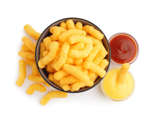 Bowl with tasty corn sticks and sauces on white background