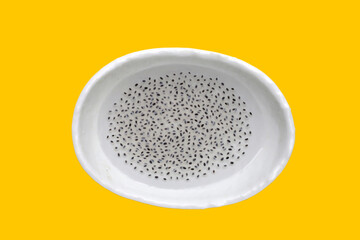 Basil seeds in syrup in bowl on yellow background.