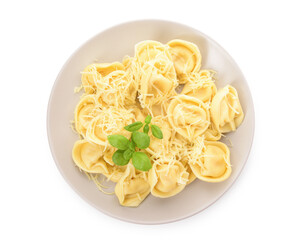 Plate of boiled dumplings with cheese and basil on white background
