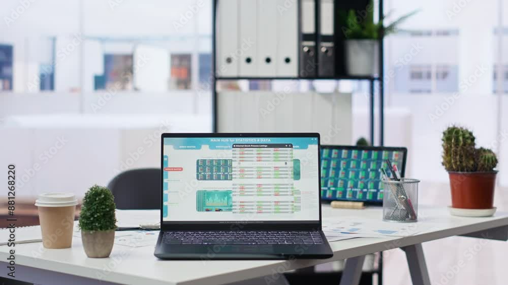 Aufkleber financial analyst workspace featuring laptop and tablet displaying stock market data and statistics.