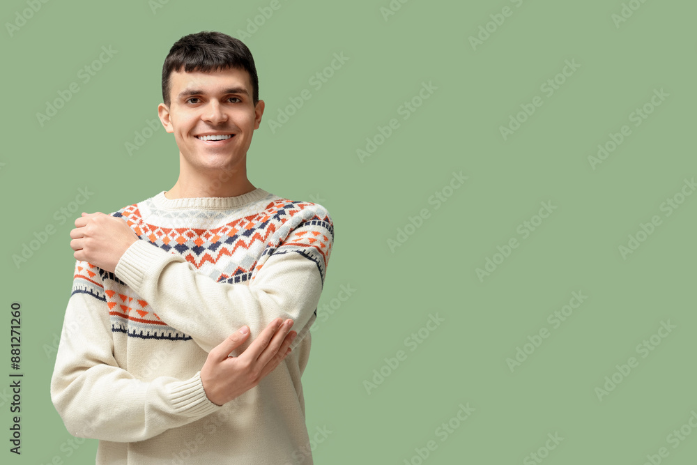 Wall mural Young deaf mute man using sign language on green background