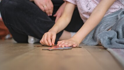 Caucasian Kid Spending Quality Time with Mother Putting Together Wooden Jigsaw Puzzle on Floor