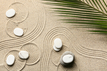 Spa stones and leaves on sand with lines. Zen concept