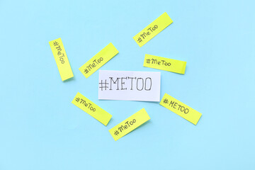 Paper sheets with hashtags METOO on blue background