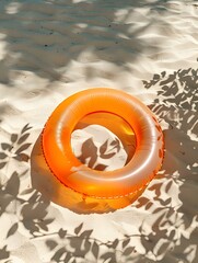 Naklejka premium Top View of a orange inflatable Swimming Ring on the Beach