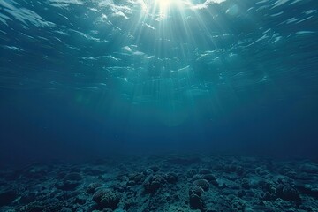 Fototapeta premium A clear blue ocean with sunlight shining through the water. The water is calm and peaceful. Concept of tranquility and serenity
