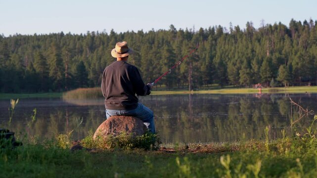 A man fishing on a peaceful lake