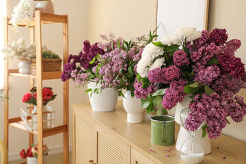 Cozy flower shop with many lilacs bouquets
