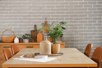 Dining table with plant, vase and magazine in kitchen