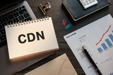 There is notebook with the word CDN. It is an abbreviation for Content Delivery Network as eye-catching image.