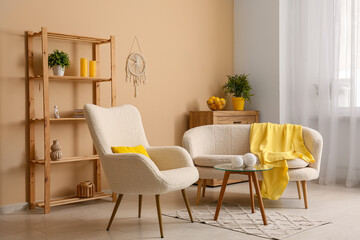 Interior of modern living room with white sofa, armchair, yellow plaid, coffee table and shelving unit
