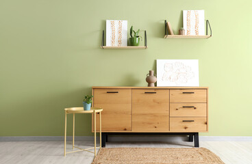 Pictures on chest of drawers and shelves in living room