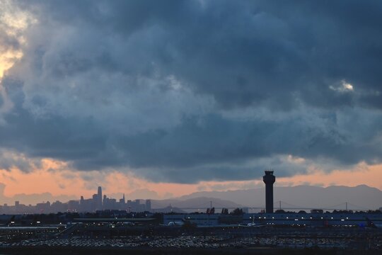Oakland airport parking lot vieiw with san francisco bay bridge and skyline sunset