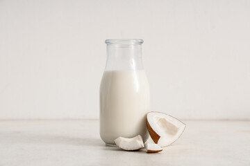 Bottle of fresh coconut milk on white background