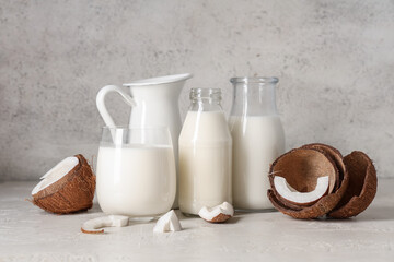 Various dishes with tasty coconut milk on grunge background