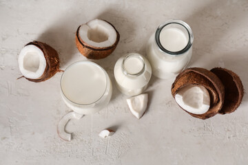 Various dishes with tasty coconut milk on grunge background