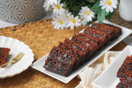 Kek Buah Kukus, a traditional Malaysian steamed fruit cake filled with dried fruits, nuts, and spices, enjoyed during celebrations.