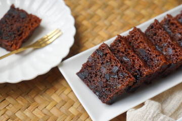 Kek Buah Kukus, a traditional Malaysian steamed fruit cake filled with dried fruits, nuts, and spices, enjoyed during celebrations.