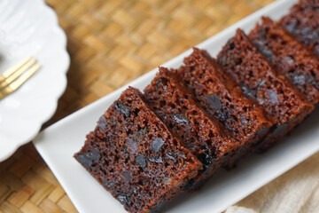 Kek Buah Kukus, a traditional Malaysian steamed fruit cake filled with dried fruits, nuts, and spices, enjoyed during celebrations.