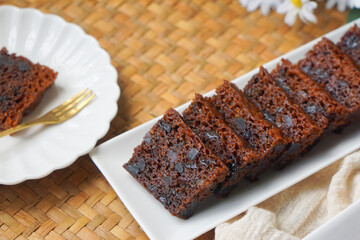 Kek Buah Kukus, a traditional Malaysian steamed fruit cake filled with dried fruits, nuts, and spices, enjoyed during celebrations.