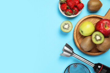 Hand blender kit and fresh fruits on light blue background, flat lay. Space for text
