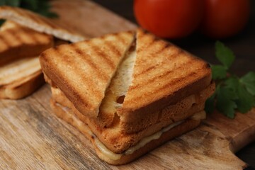 Pieces of toasted bread with melted cheese on table, closeup