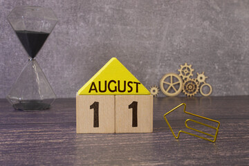 August 11th. August 11 wooden cube calendar with blur objects on background