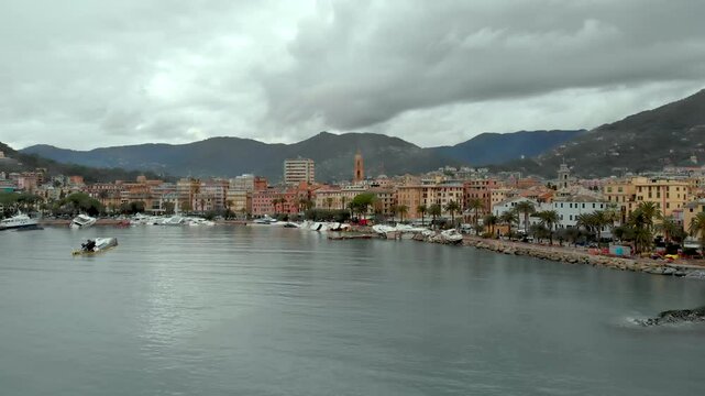 Aerial view of Carlo Riva Marina destroyed by powerful storm. Extreme disaster aftermath, sunken yachts and boats, piles of debris, catastrophic weather events damage. Rapallo, Italy.