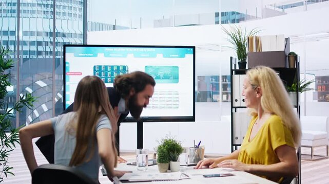 Employee choking in office, being helped by quick thinking coworker performing Heimlich maneuver. Worker offering first aid to colleague while coworker calls for ambulance, camera A