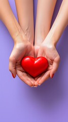 Young women hands holding red heart on purple background, health care, donate and family insurance concept,world heart day, world health day, CSR responsibility, adoption foster family