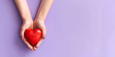 Obraz premium Young women hands holding red heart on purple background, health care, donate and family insurance concept,world heart day, world health day, CSR responsibility, adoption foster family
