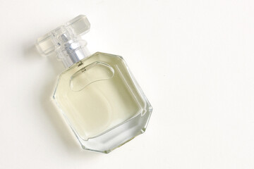 A bottle of perfume on a white background with space for text copy. Flat lay, top view.