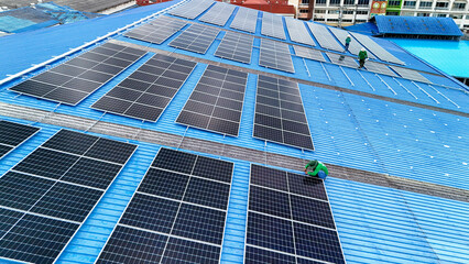 top aerial of engineer men inspects construction of solar cell panel or photovoltaic cell at roof...