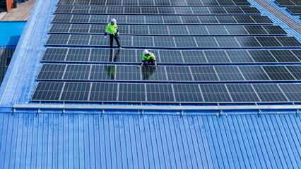 engineer man inspects construction of solar cell panel or photovoltaic cell by electronic device....