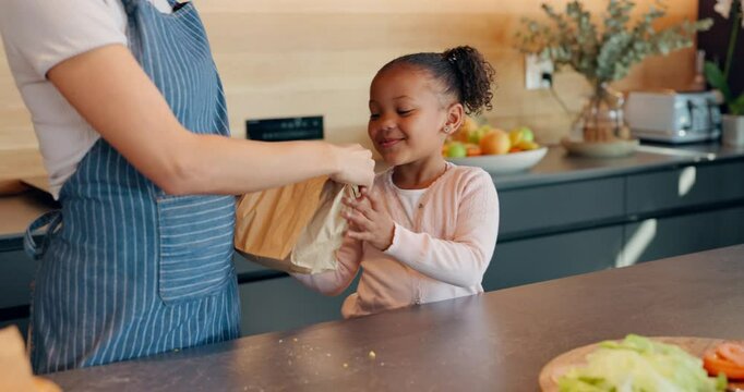 Mother, daughter and packing lunch with bag for morning, healthy snack or meal to school at home. Mom helping happy child, young kid or little girl getting ready for kindergarden with food at house