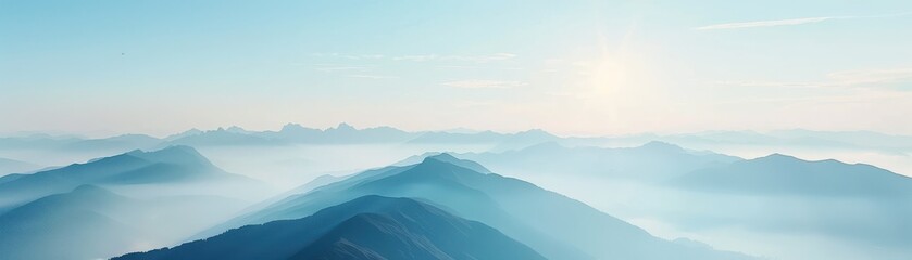 Fototapeta premium Beautiful panoramic view of mountain ranges enveloped in mist at sunrise, creating a peaceful and serene natural landscape.