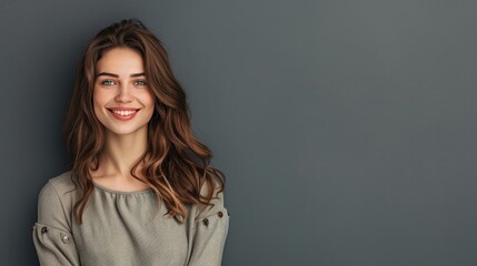 Fototapeta premium Half-body photo of a beautiful woman in a stylish outfit, smiling with a solid grey background and plenty of copy space above