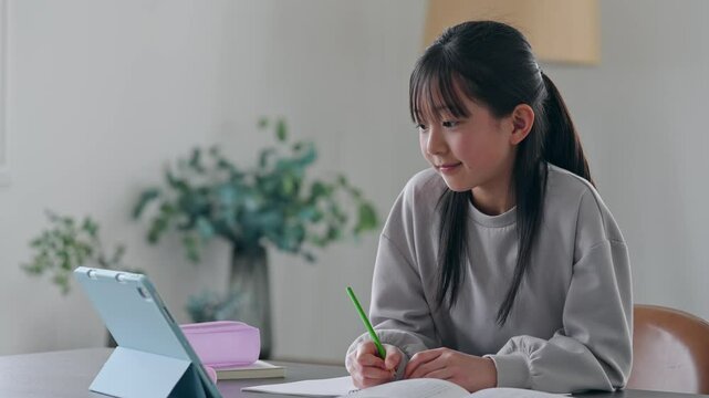 タブレットPCを見ながら勉強する女の子