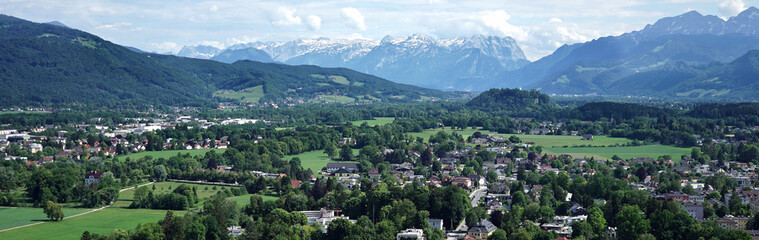 Panoramic View of Salzburg with snow-capped mountains in the background.
