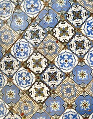 Beautiful blue, white, yellow, and brown colored moroccan ceramic tile ground interior flooring material isolated on vertical ratio background.