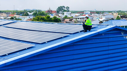 engineer man inspects construction of solar cell panel or photovoltaic cell by electronic device....
