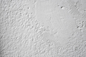 White paint and plaster grunge texture on a wall, abstract pattern backdrop with vignette, close up